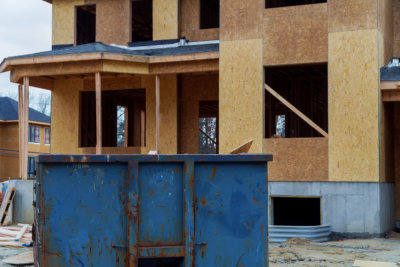 Dumpster, recycle waste and garbage bins near new construction site