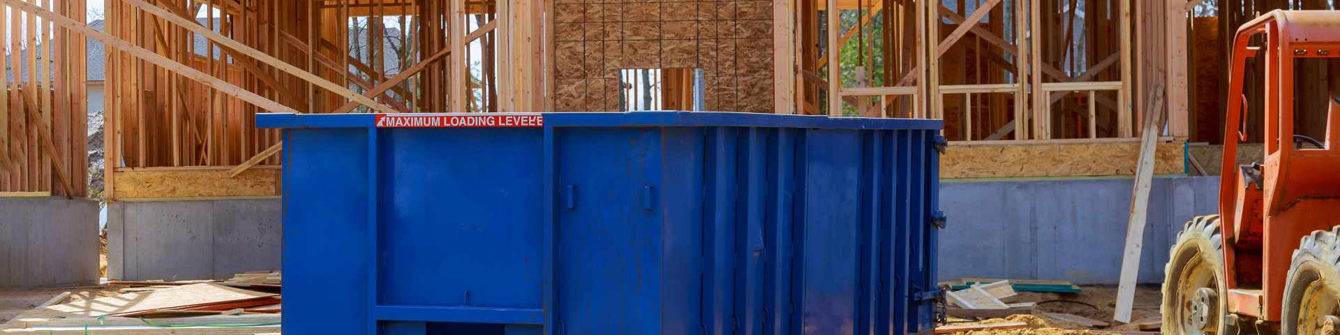 Old and used construction material in the new building frame of a new house under construction