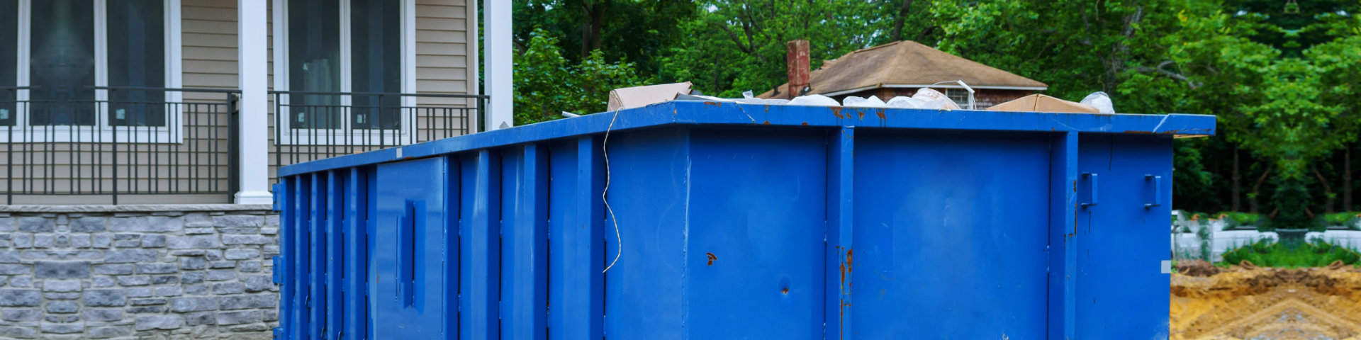 Full construction rubbish bin with loads at construction site waste debris container, garbage bricks and material from demolished house